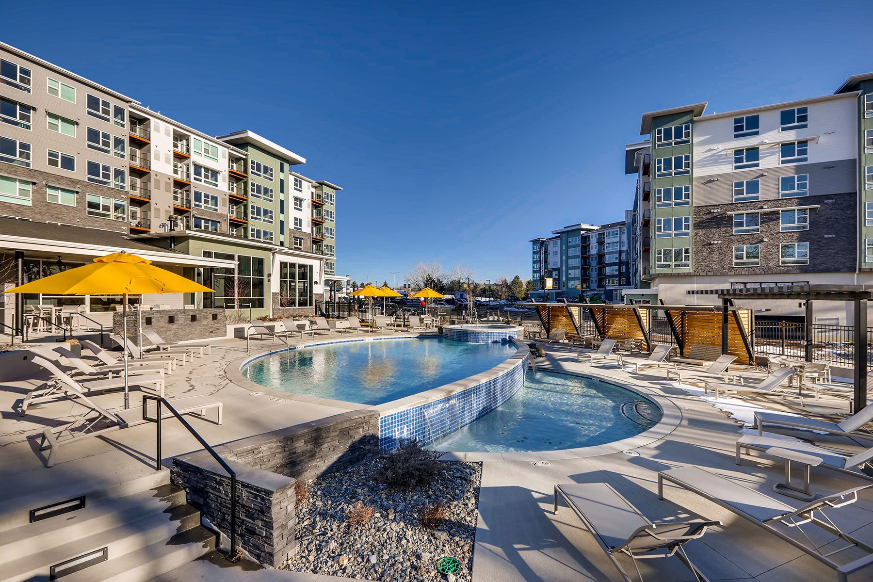 Exterior of High Line Pointe Apartment buildings and swimming pool in the center..