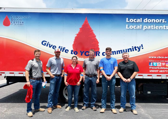 Group of people in front of a Community Blood Center truck.