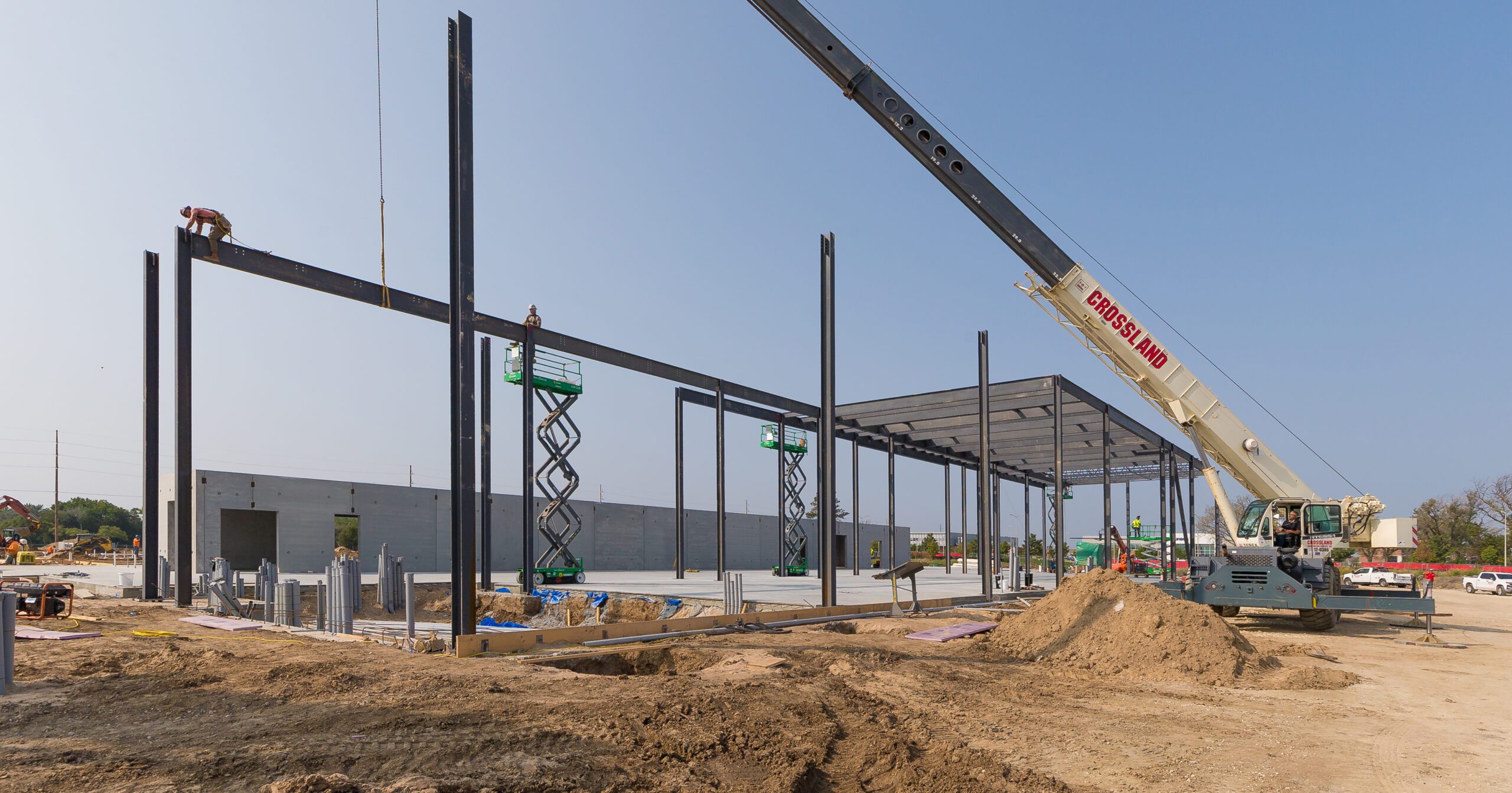 A crane is being used to build a steel structure.