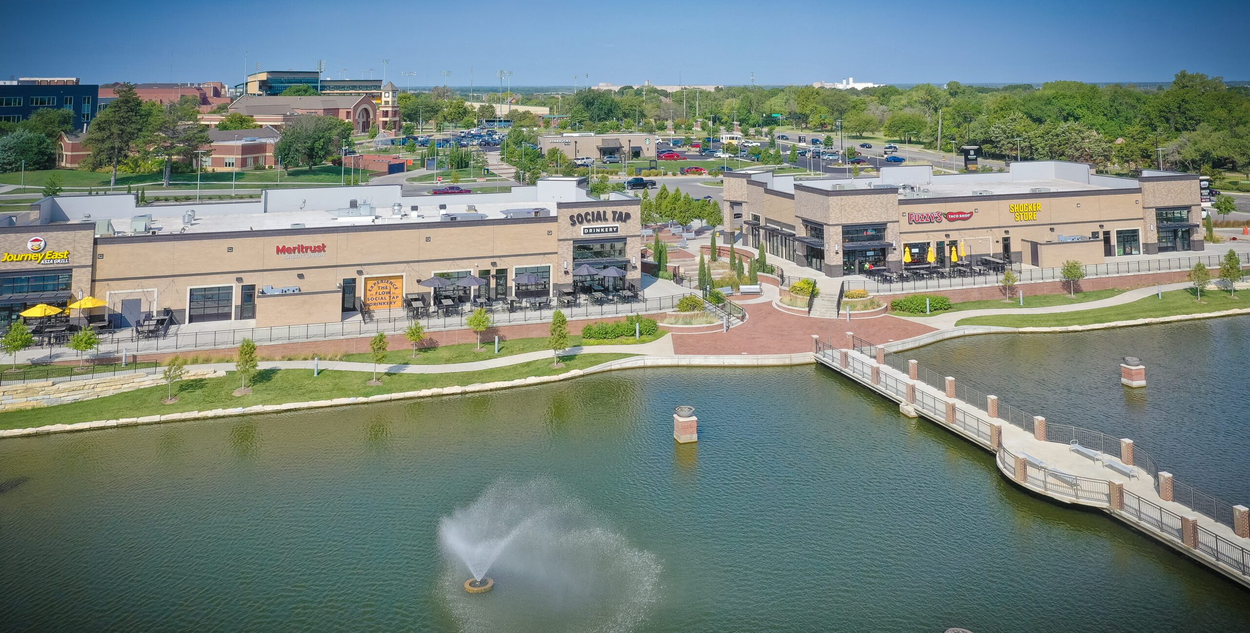 An aerial view of a shopping center with a fountain.