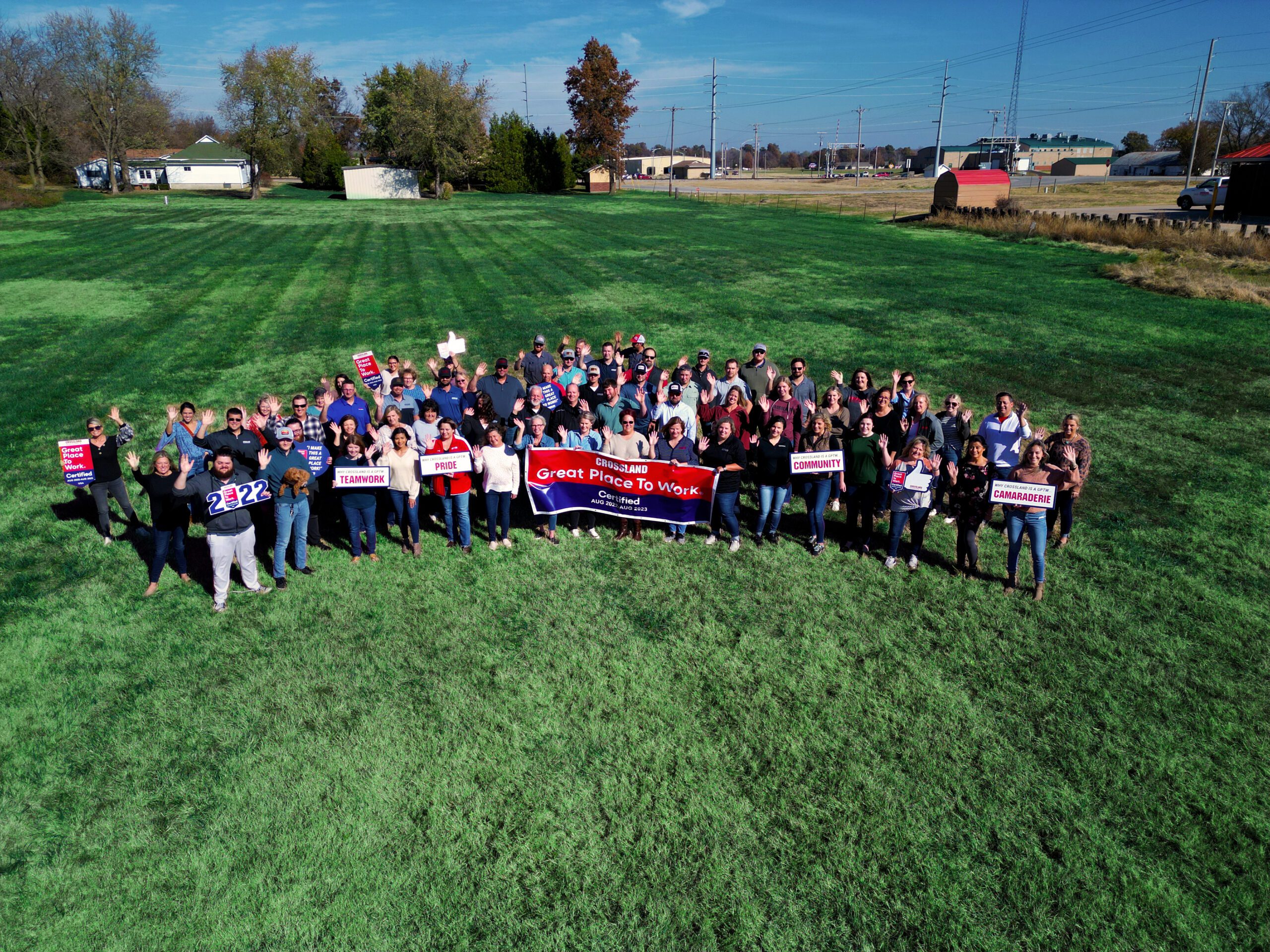 A group of people posing for a photo in a field.