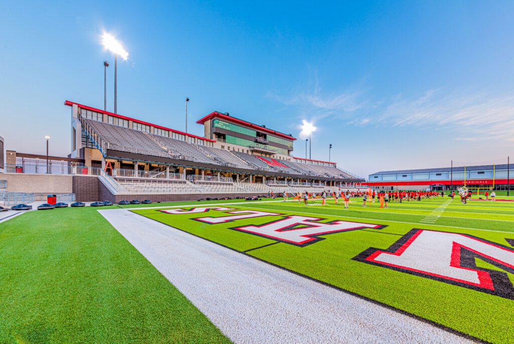 A football field with lights on it.