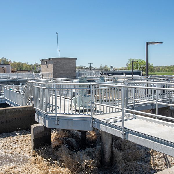 A water treatment plant with metal railings and a walkway.