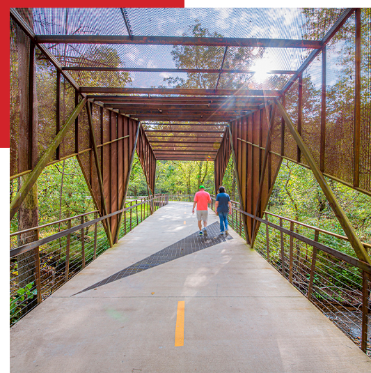 Couple walking across a bridge.