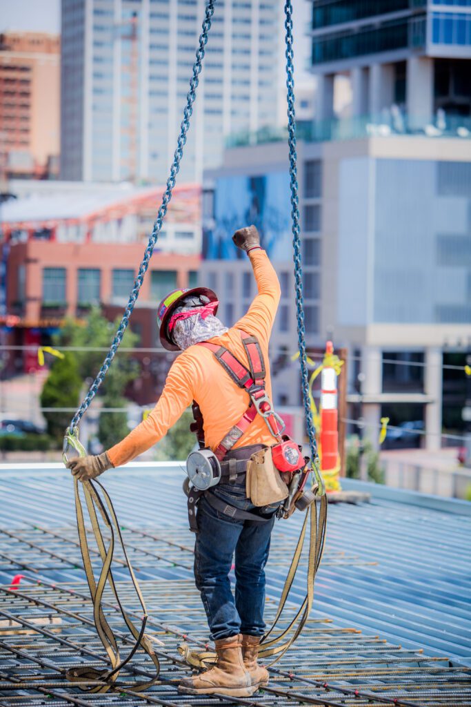 A construction worker is working on a roof.