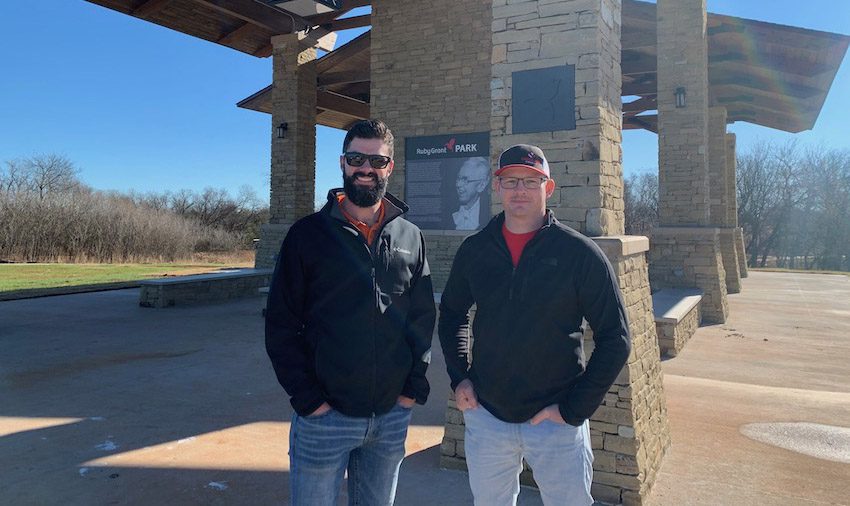 Two Crossland Construction employees posing outside.