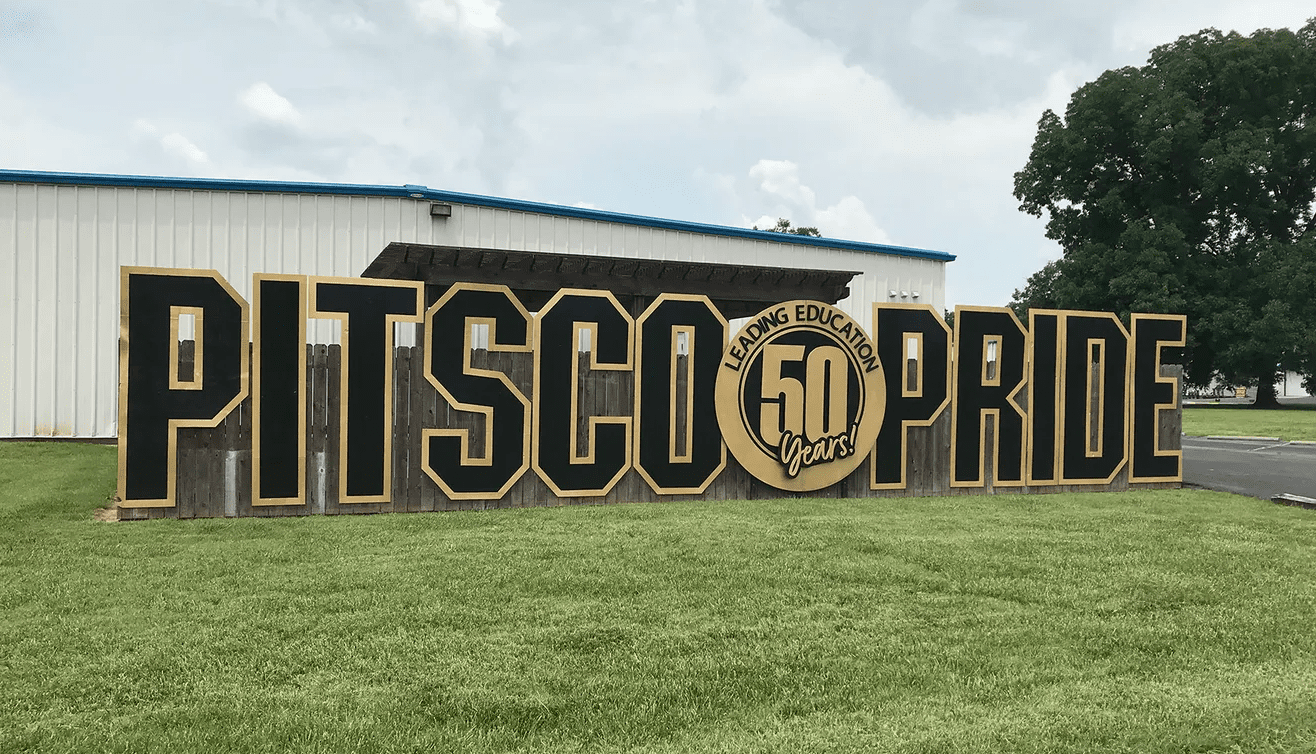 Pitsco Pride sign in front of warehouse which was purchased by Crossland.