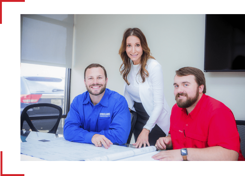 Three Crossland Construction employees smiling.