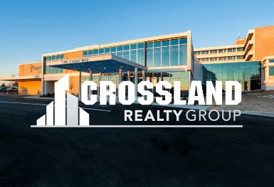 ݮRealty Group logo with large building in the background.