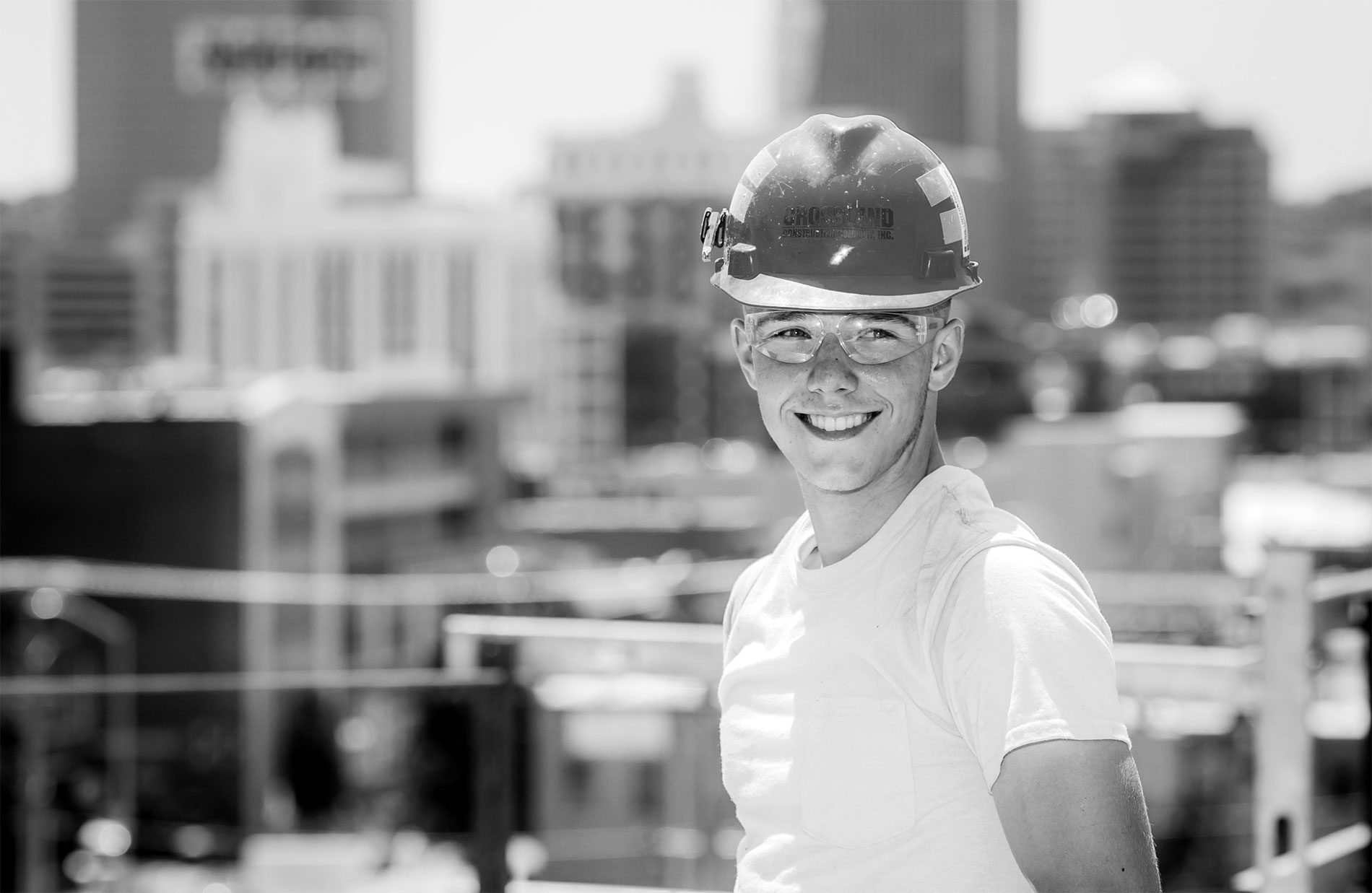 Young construction worker wearing hardhat.