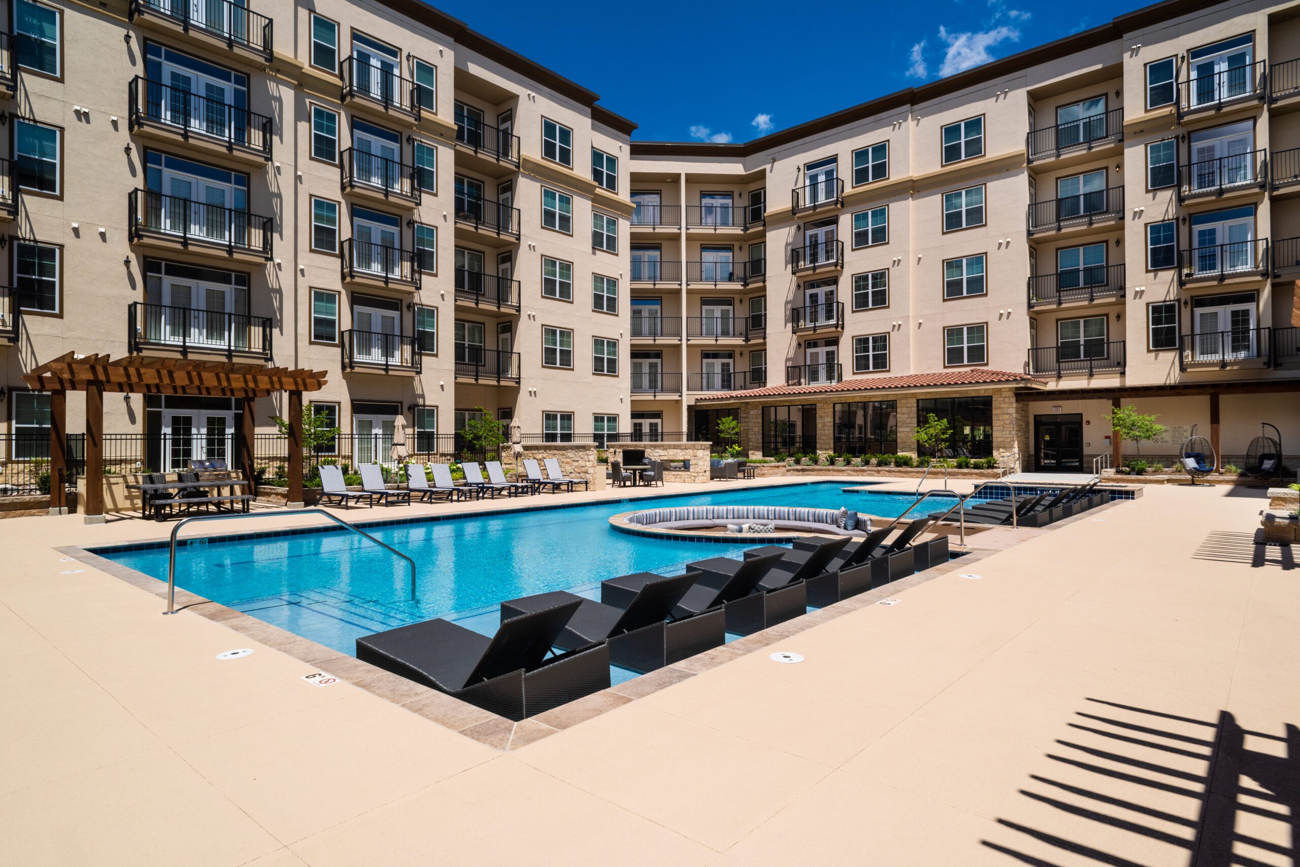 Exterior of Mission Trails buildings with swimming pool in the center.