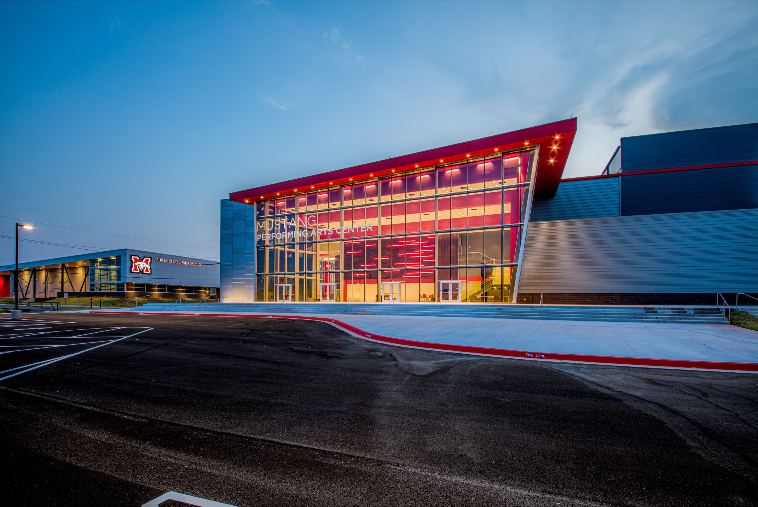 The exterior of a large school at dusk.