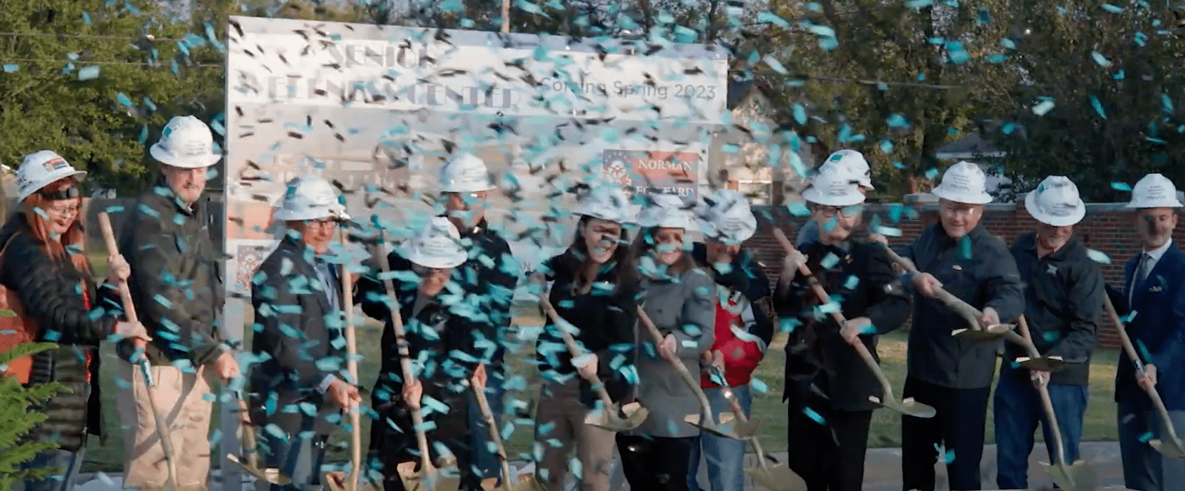 A group of people with shovels and confetti.