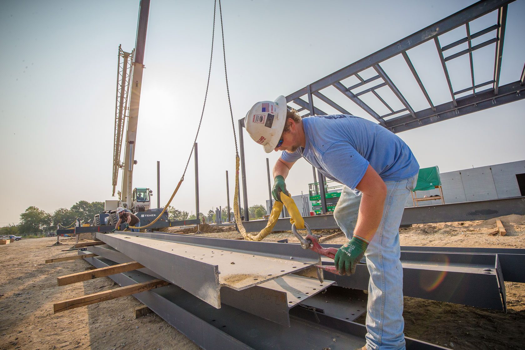 Crossland metal builders busy working outside on a job site.