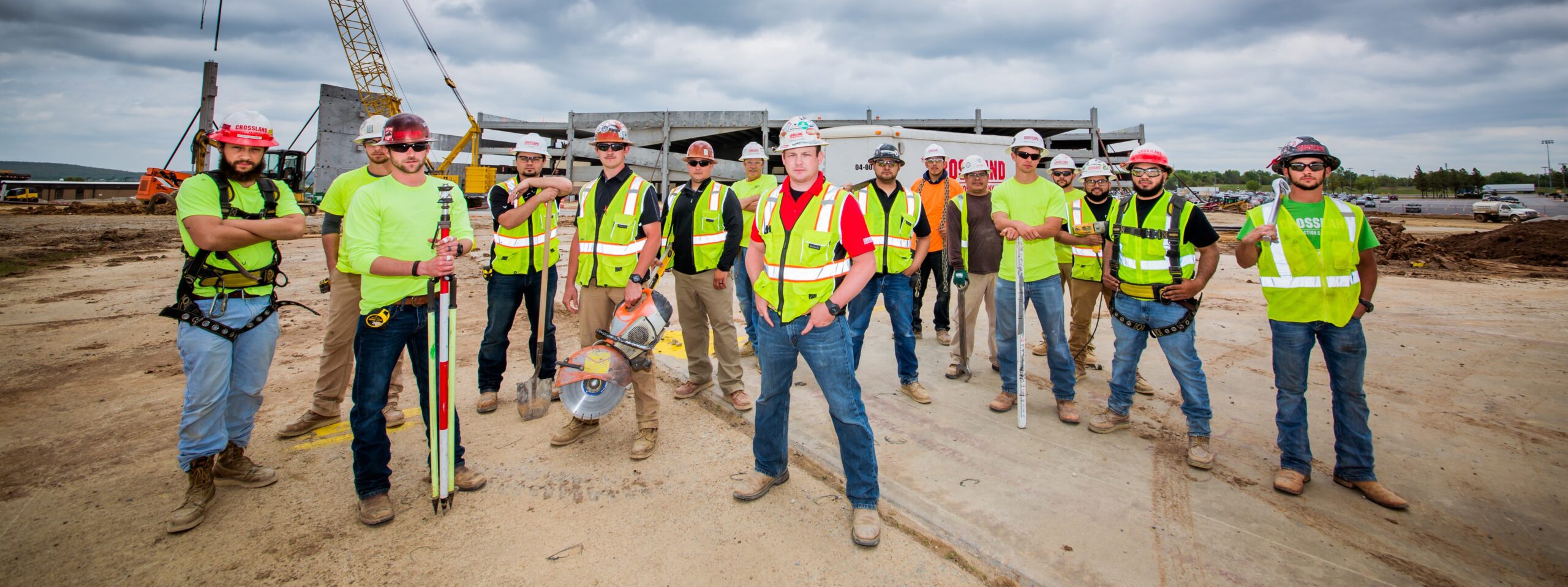 Group of Crossland construction workers wearing PPE posing on a job site.