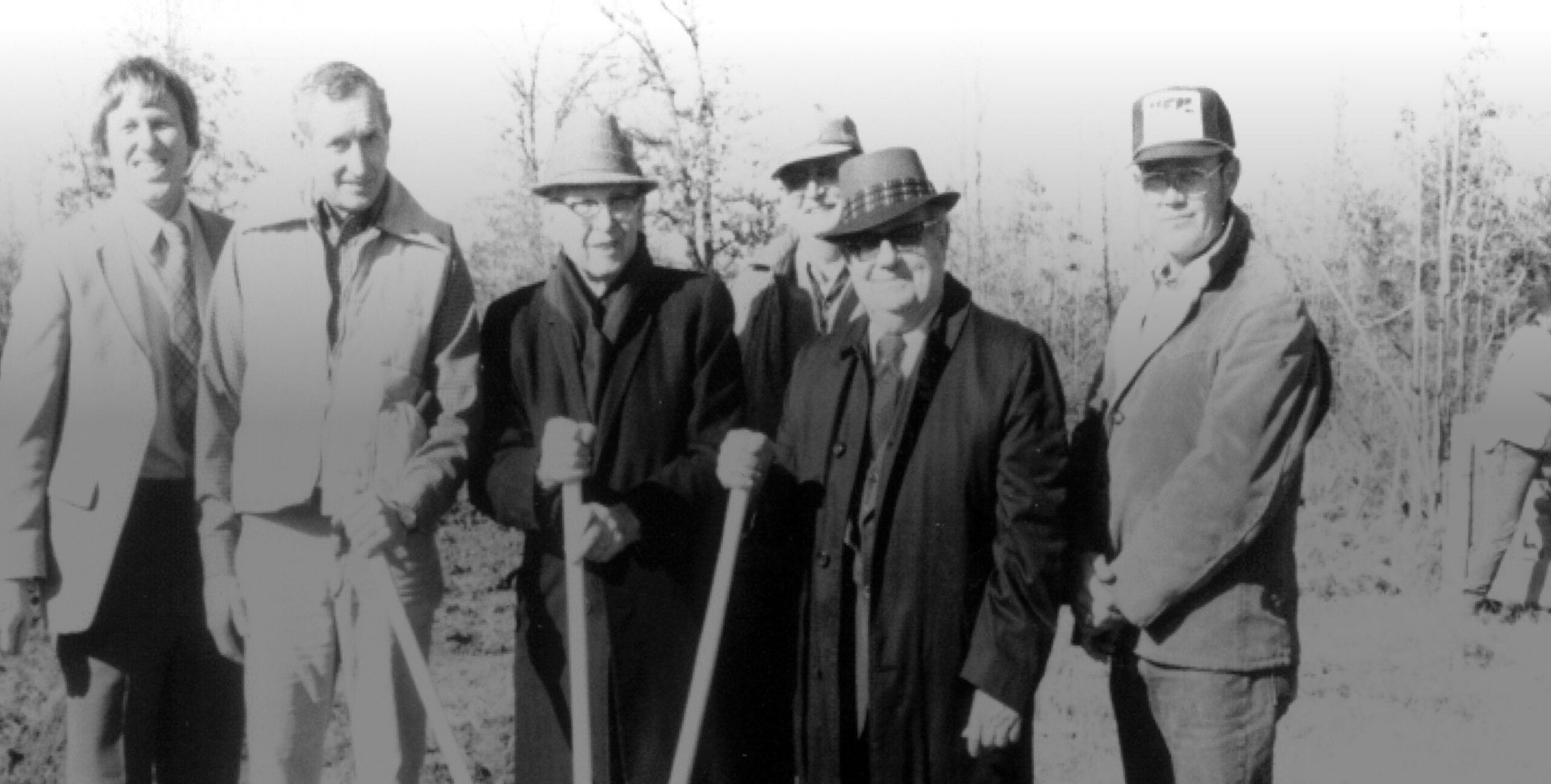 Group of men standing outside.